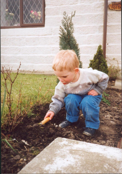 young boy digging in his garden 
09-People and Family-02-People-000-General

Keywords: 1990