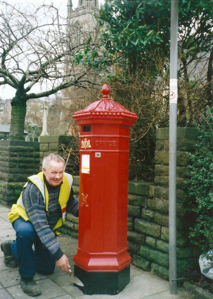 Painting and repairing  the post box on Bridge Street
people
