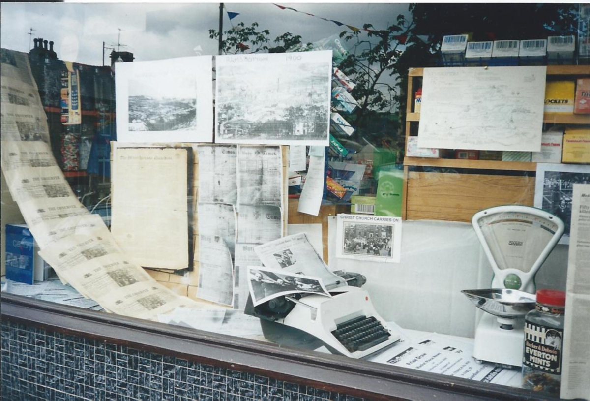 Market Place News - J &R Holloway. Window decorated for Millenium Festival.  catalogued at Bury Archives as RHS/21/3/2/32
03 - Shops, Restaurants & Hotels - 02 - Individual shops
Keywords: Bury-Archive