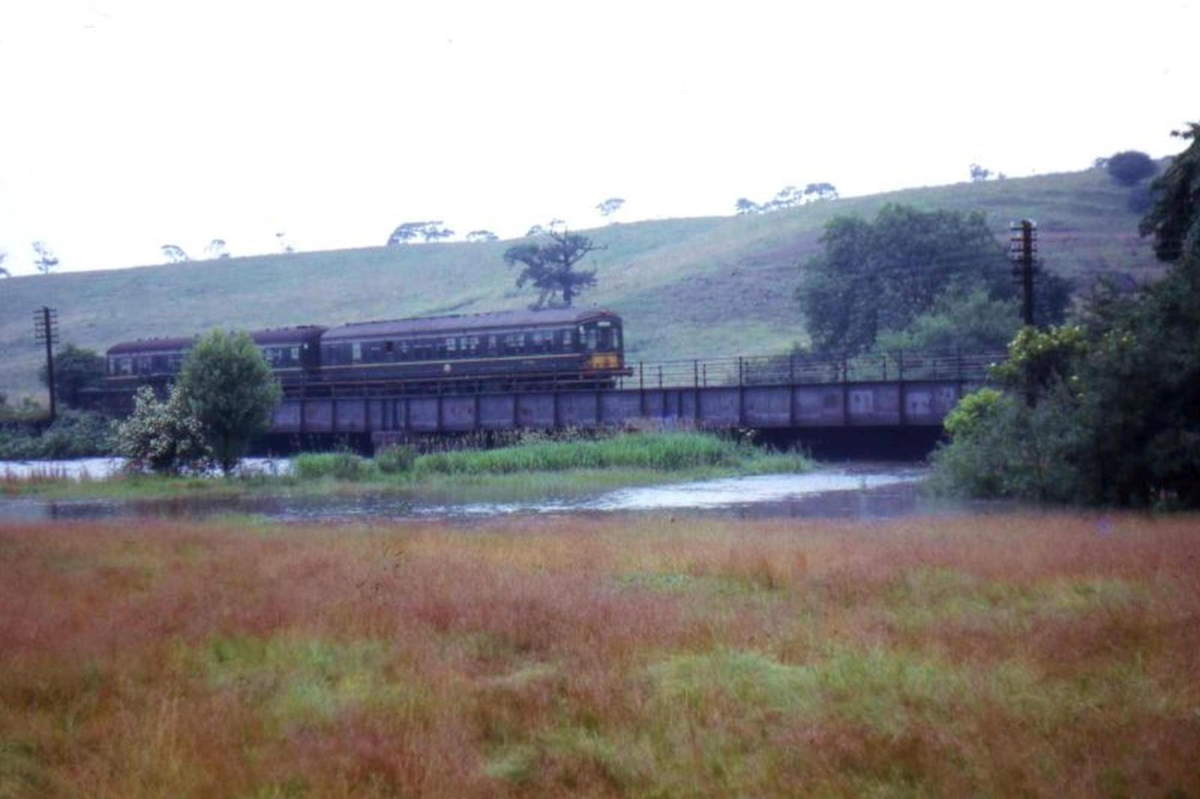 August Bank Holiday weekend 1964 â€“ a DMU crossing the Irwell south of Ramsbottom, unaffected by the rising flood water.
16 - Transport - 03 - Trains and Railways
Keywords: Bury-Archive